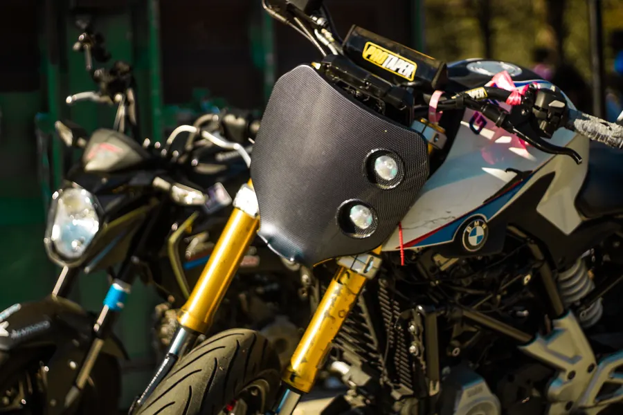 BMW motorcycle headlight and gold forks, close up