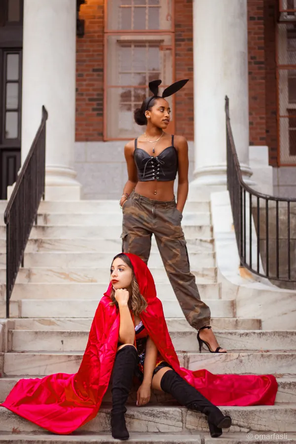 Two women in costume on stone steps