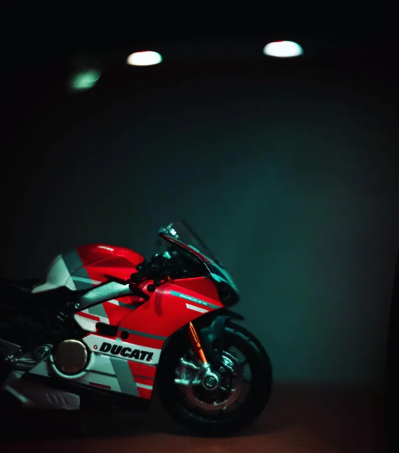 Red Ducati superbike in a dark garage