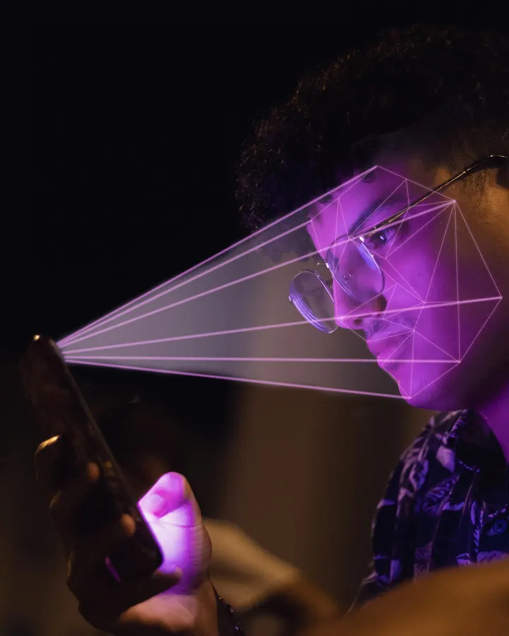 Man lit by a phone with a beam of light scanning his face