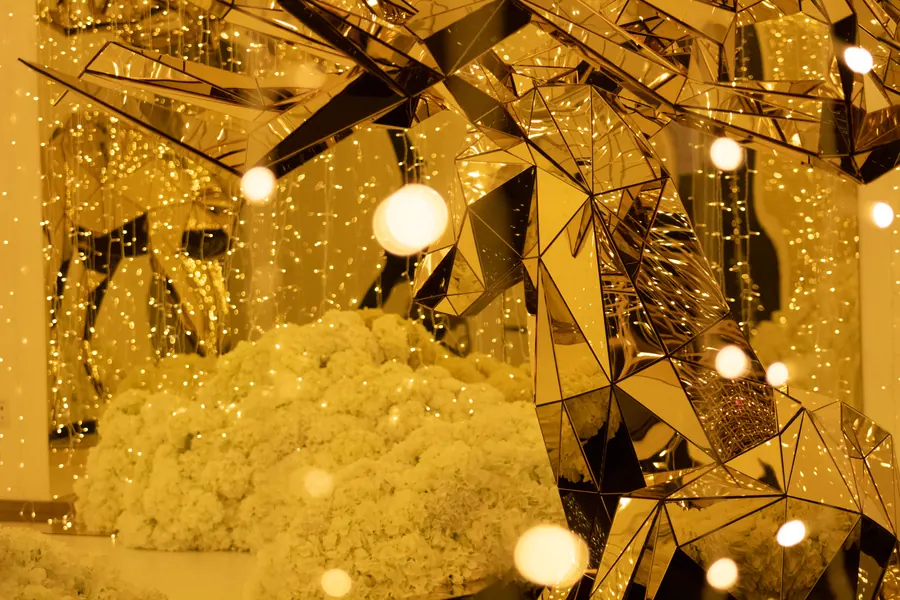 Gold mirrored installation with string lights