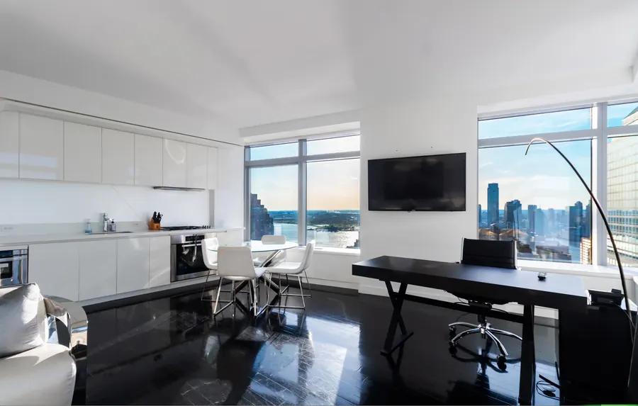 Open living room and kitchen with skyline windows