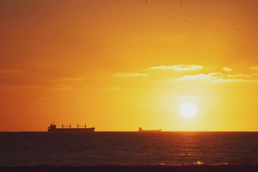 Sun setting over the Atlantic off Morocco with a ship on the horizon