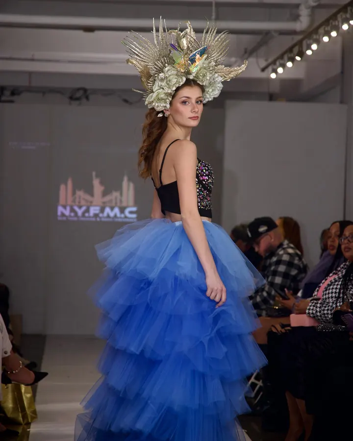 Model in a blue tulle skirt and floral crown on the runway