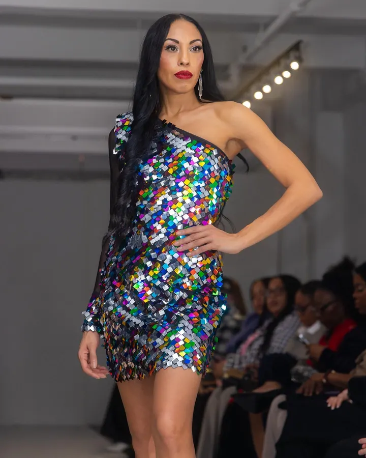 Model in a sequin mini dress on the runway