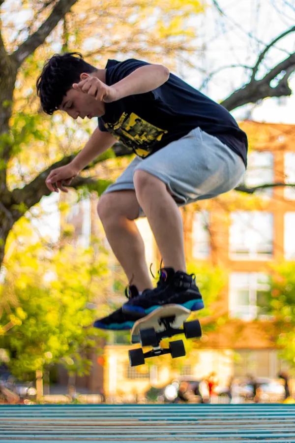 Skateboarder mid-air in a park